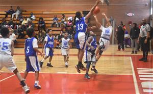 Boy goes up for a shot at the basket